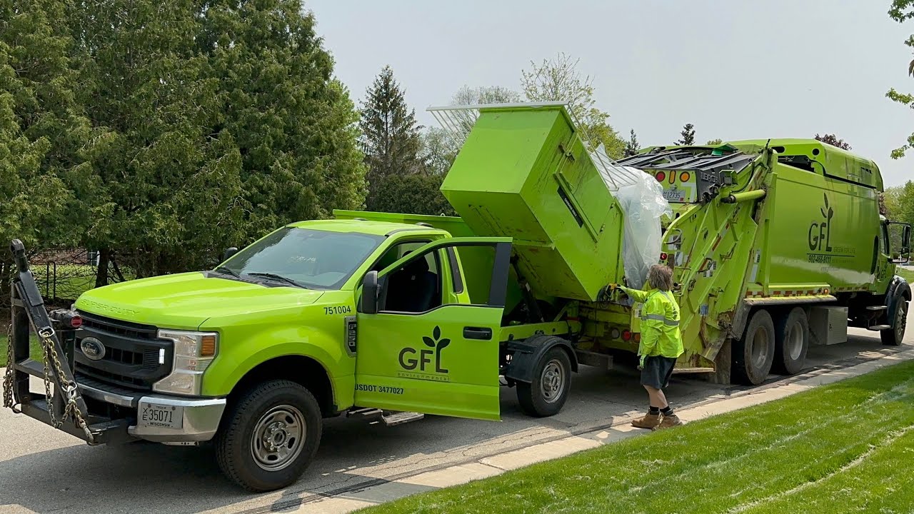 Mini Garbage Truck Dumping a Mattress into a Massive Leach Rear Loader