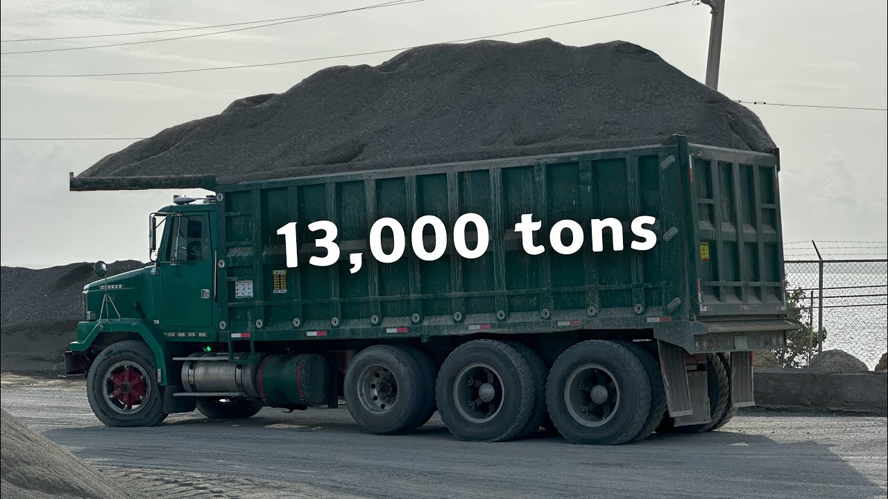 Trucks are unloading 13,000  tons of materials onto the barge.