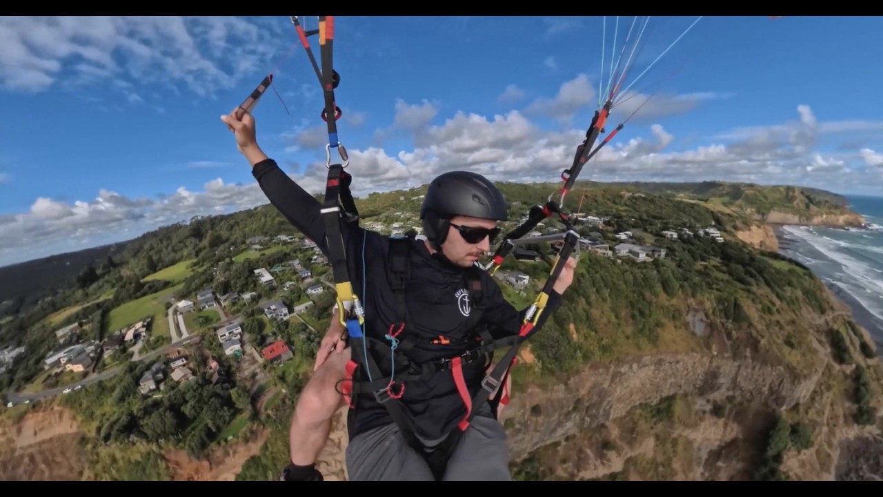 Nick gets airborne in New Zealand - tandem paragliding at Muriwai