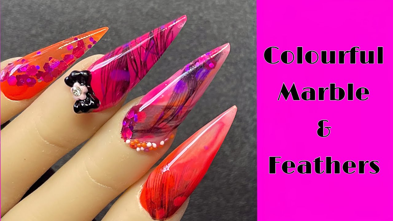 Bright Acrylic Nails With Encapsulated Feathers And Glitter