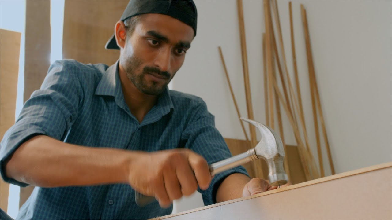 Shot of an Indian carpenter hitting the nail with the hammer | Indian Stock Footage | Knot9