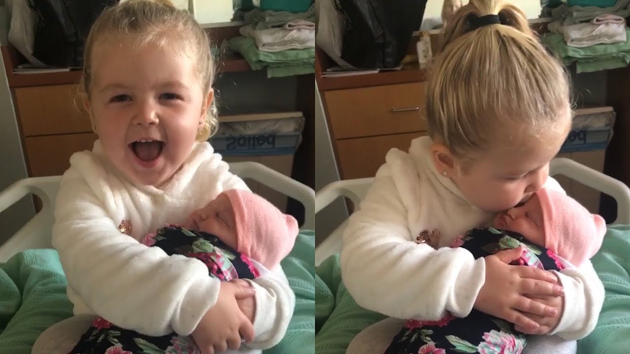 Heartwarming moment 3-year-old girl meets her baby sister for the first time