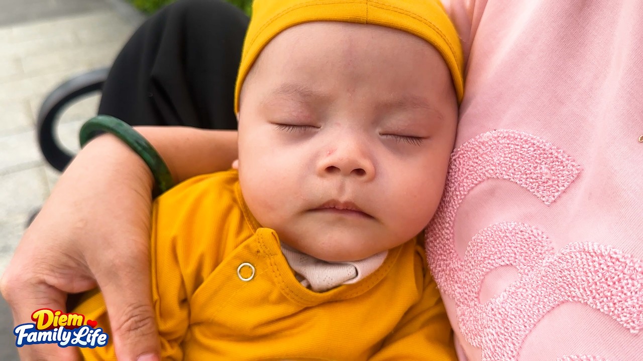 Baby Kim slept soundly while her mother carried her for a walk