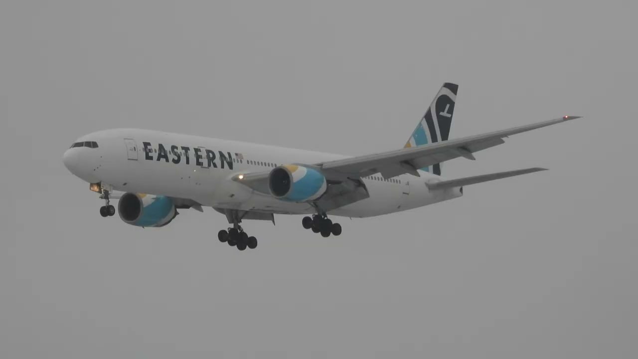 Eastern Airlines Boeing 777-212ER N825KW Landing in the Rain and Takeoff Runway 06  CYQB