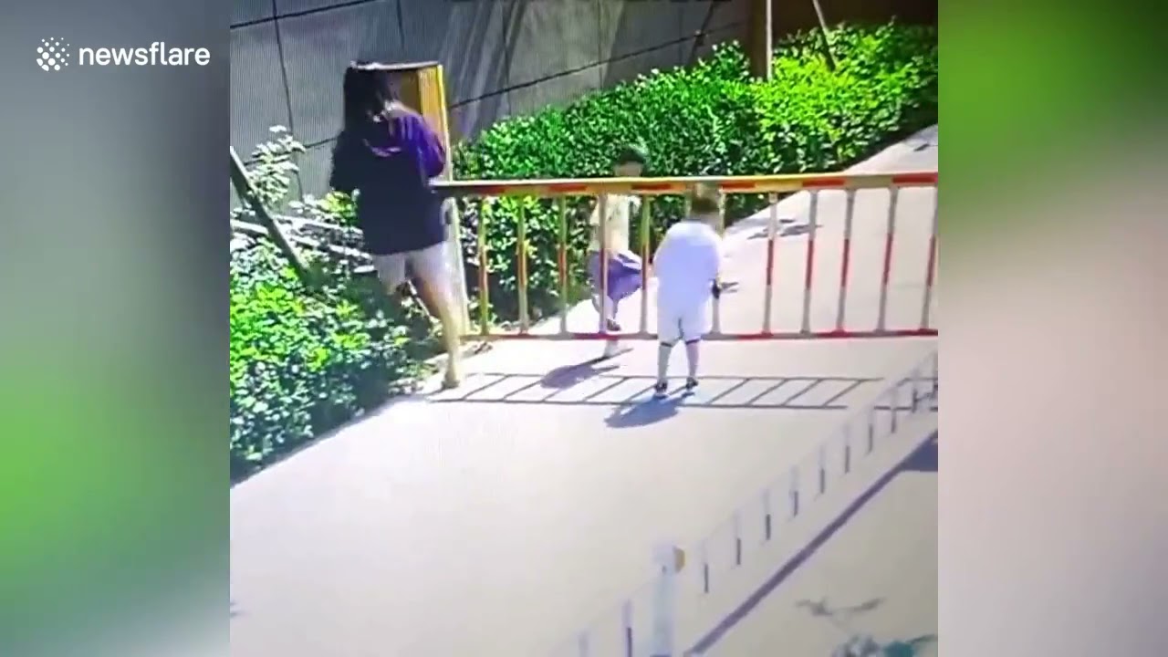 Boy lifted into air after getting head stuck in barrier gate in China