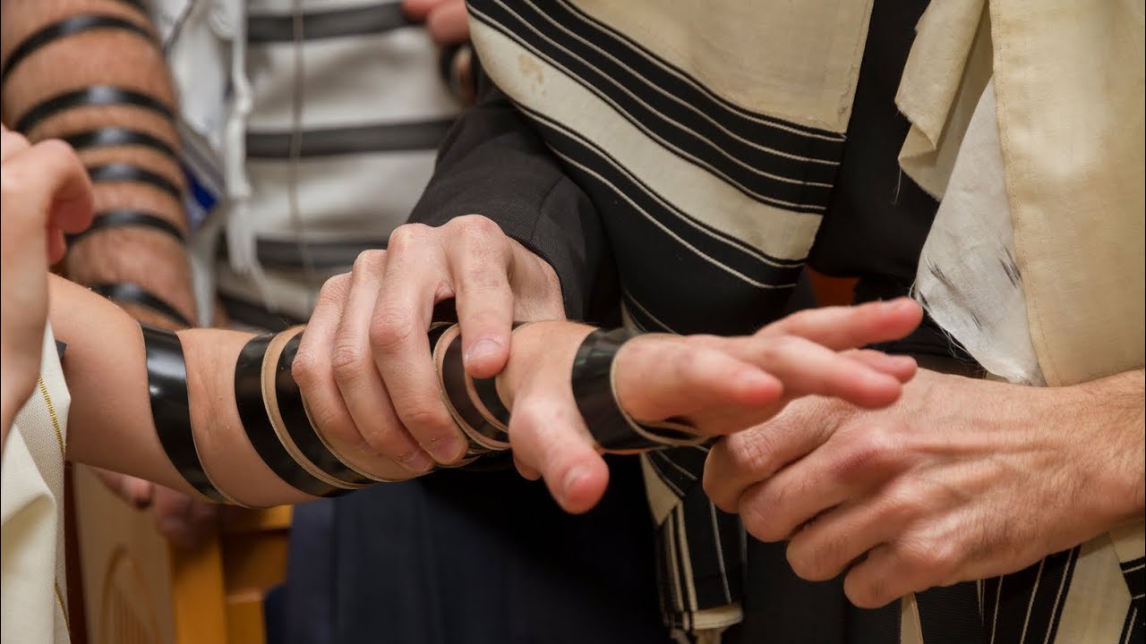 Why do Chabad Chassidim roll their tefillin outward, rather than inward like the common minhag?