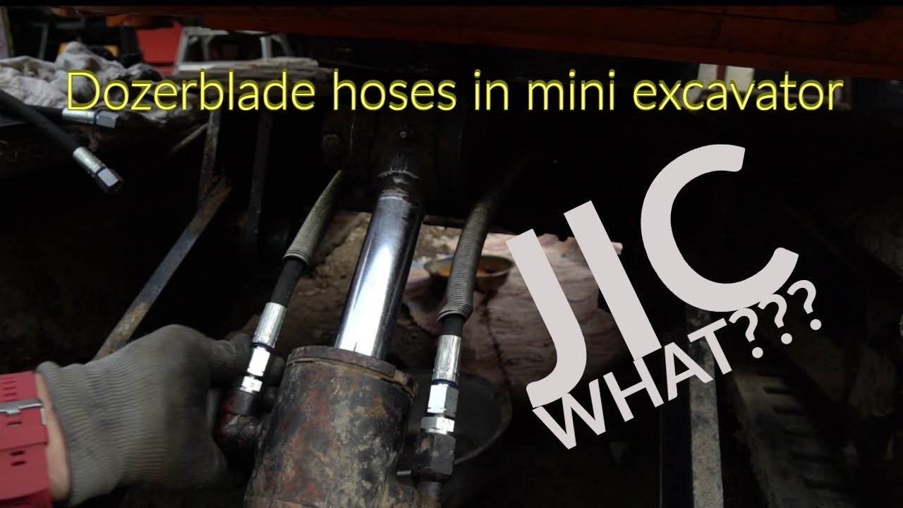 Changing dozer blade hydraulic hoses in a mini excavator.
