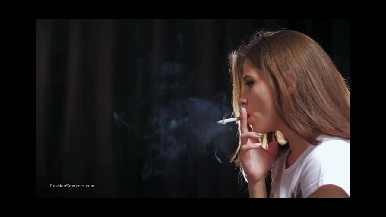 Girl smoking heavily in jeans 