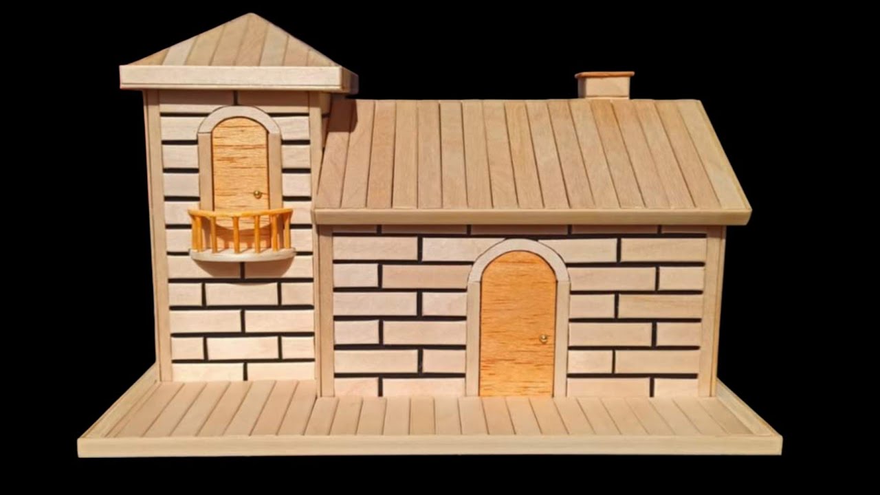 casa de bricolaje en miniatura con ladrillos,hecha de carton  y palitos de helado