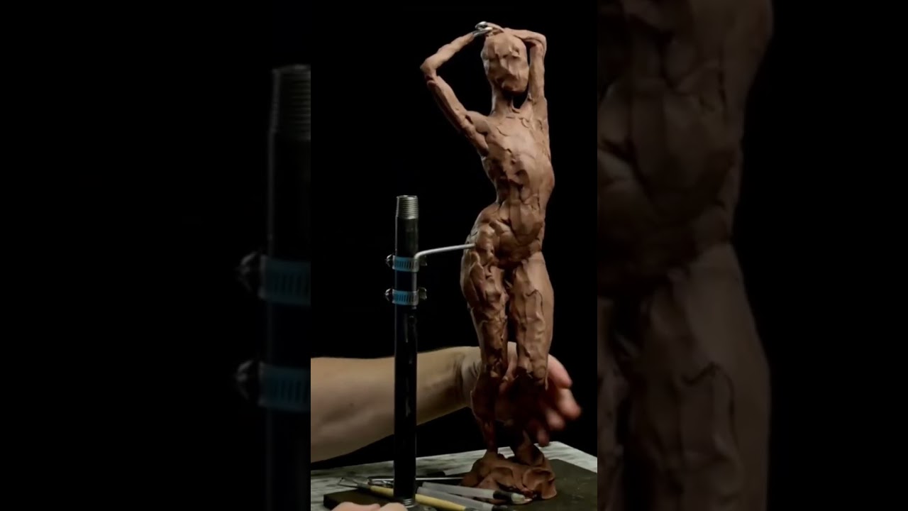 Adding clay to the leg on a female figure sculpture in brown clay. #figuresculpting