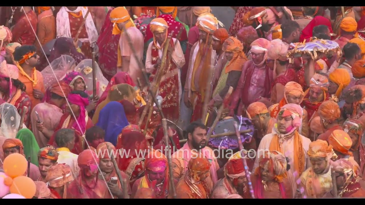 Local village women play traditional Lathmar Holi at Barsana in India's Uttar Pradesh cow belt state