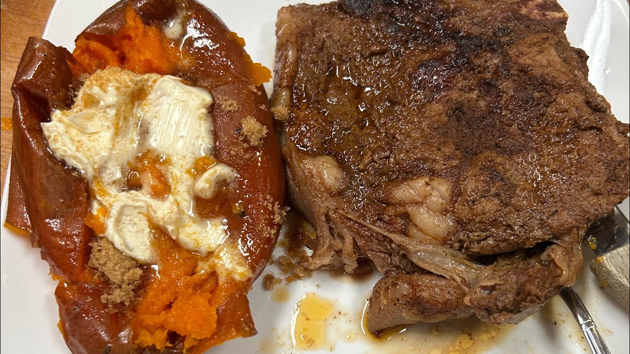Perfect steak in an iron skillet and sweet potatoes.