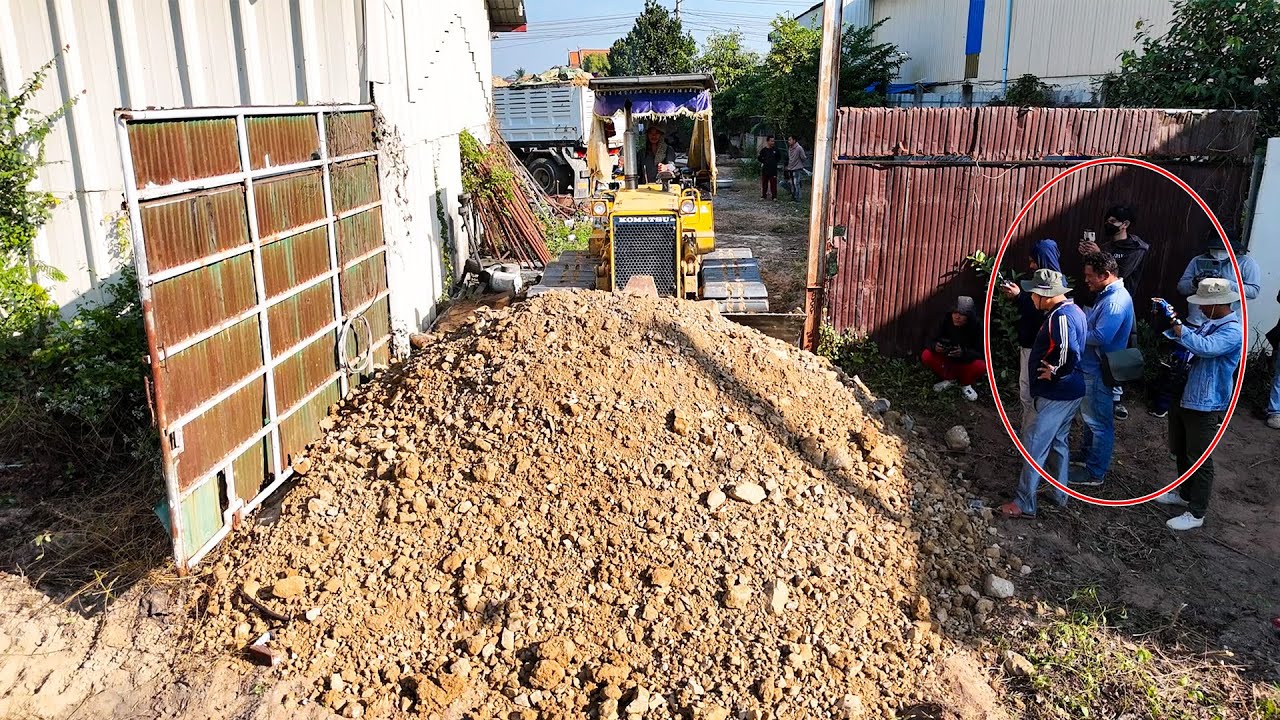 Nice bulldozer starts new project landfill with dump trucks 