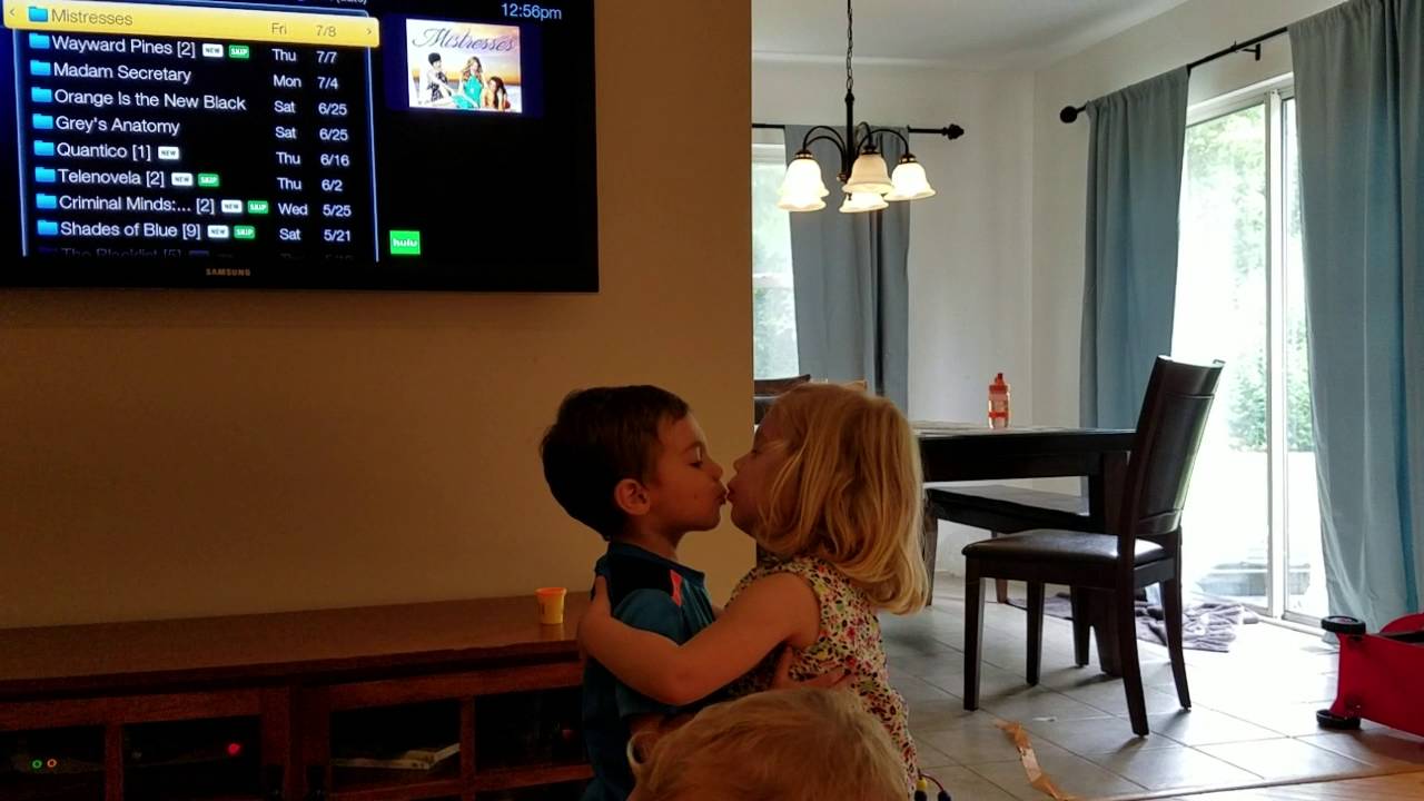 Adorable toddlers hug and kiss goodbye
