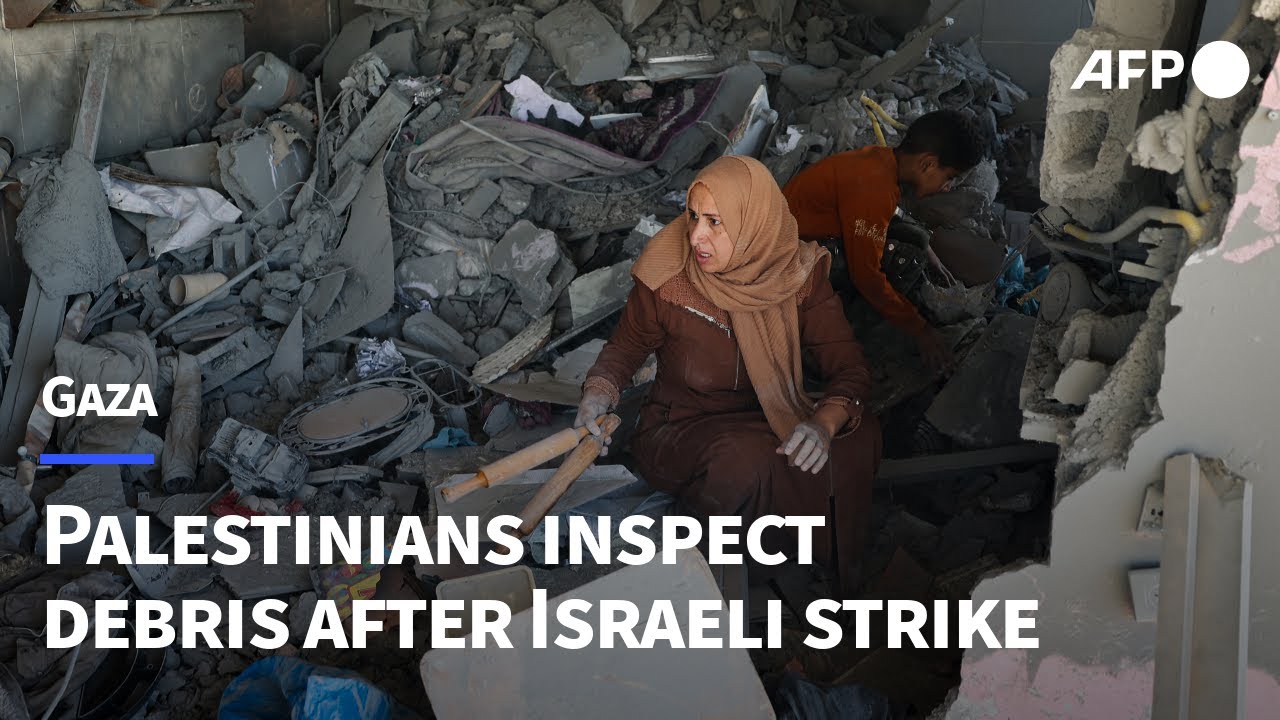 Palestinians inspect debris after Israeli strike on Gaza's Rafah | AFP