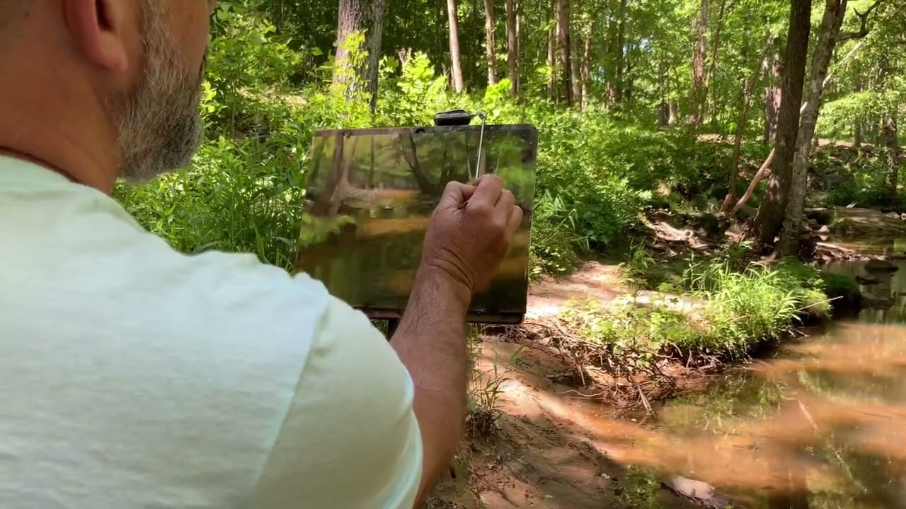 Plein air painting a creek scene with acrylics