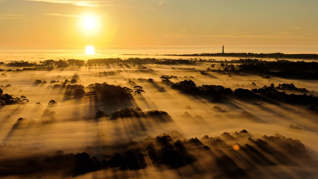 Beautiful Sunrise over Fog covering Small Town