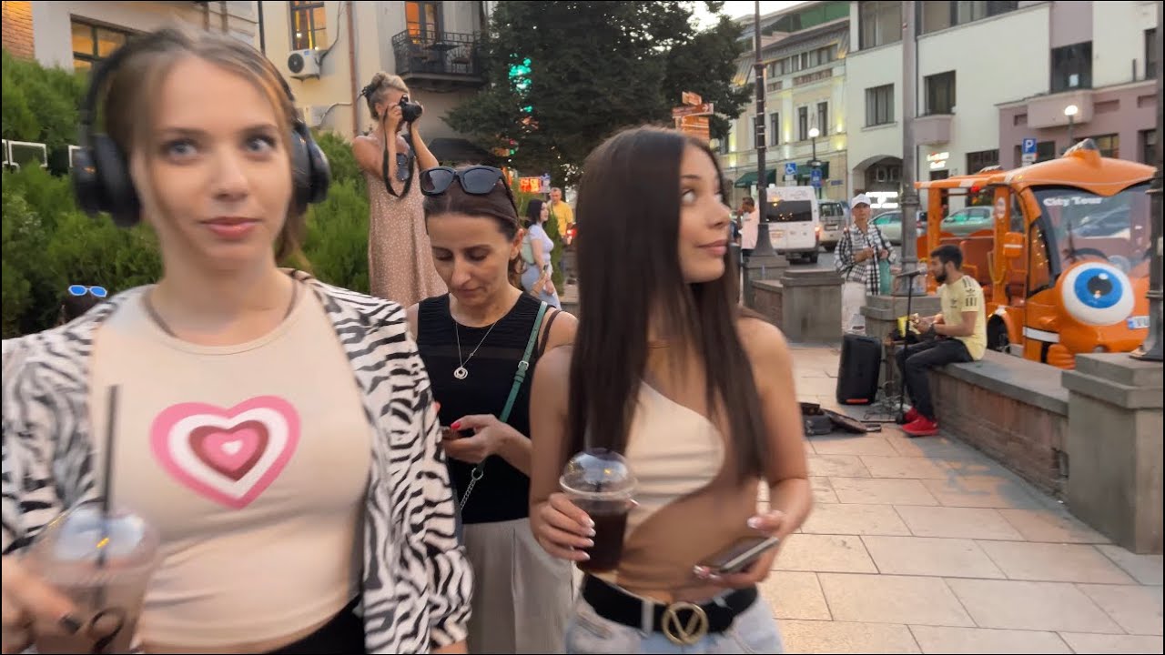 Atmosphere in Tbilisi in Georgia // The street singer sings divinely // People rest on the street
