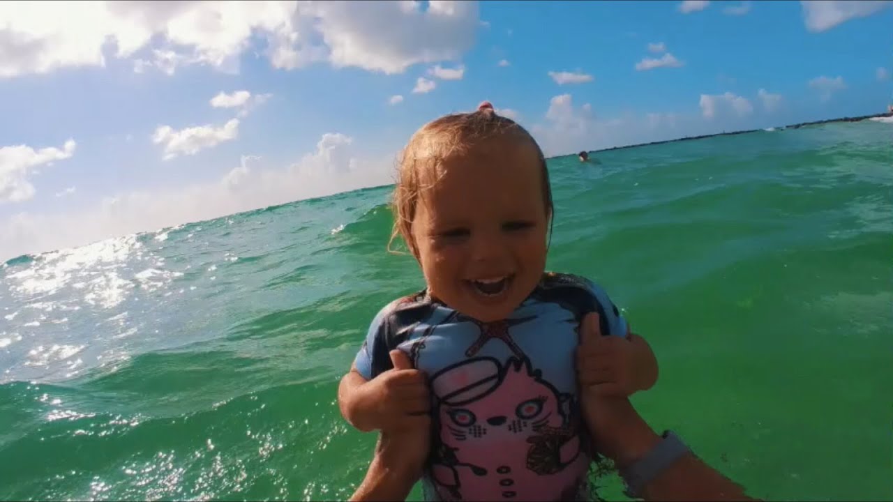 Naomi is swimming on her back for first time in the Ocean at Miami Beach