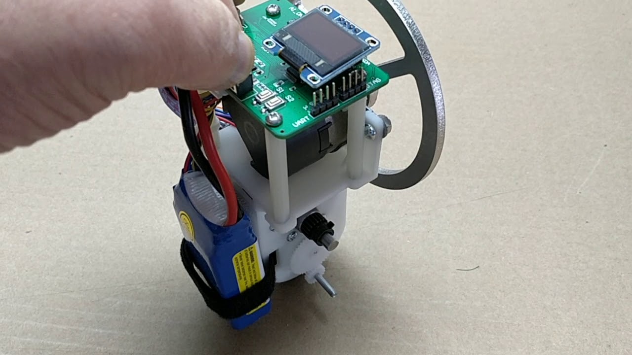 Unicycle robot balances on a single wheel using a reaction wheel