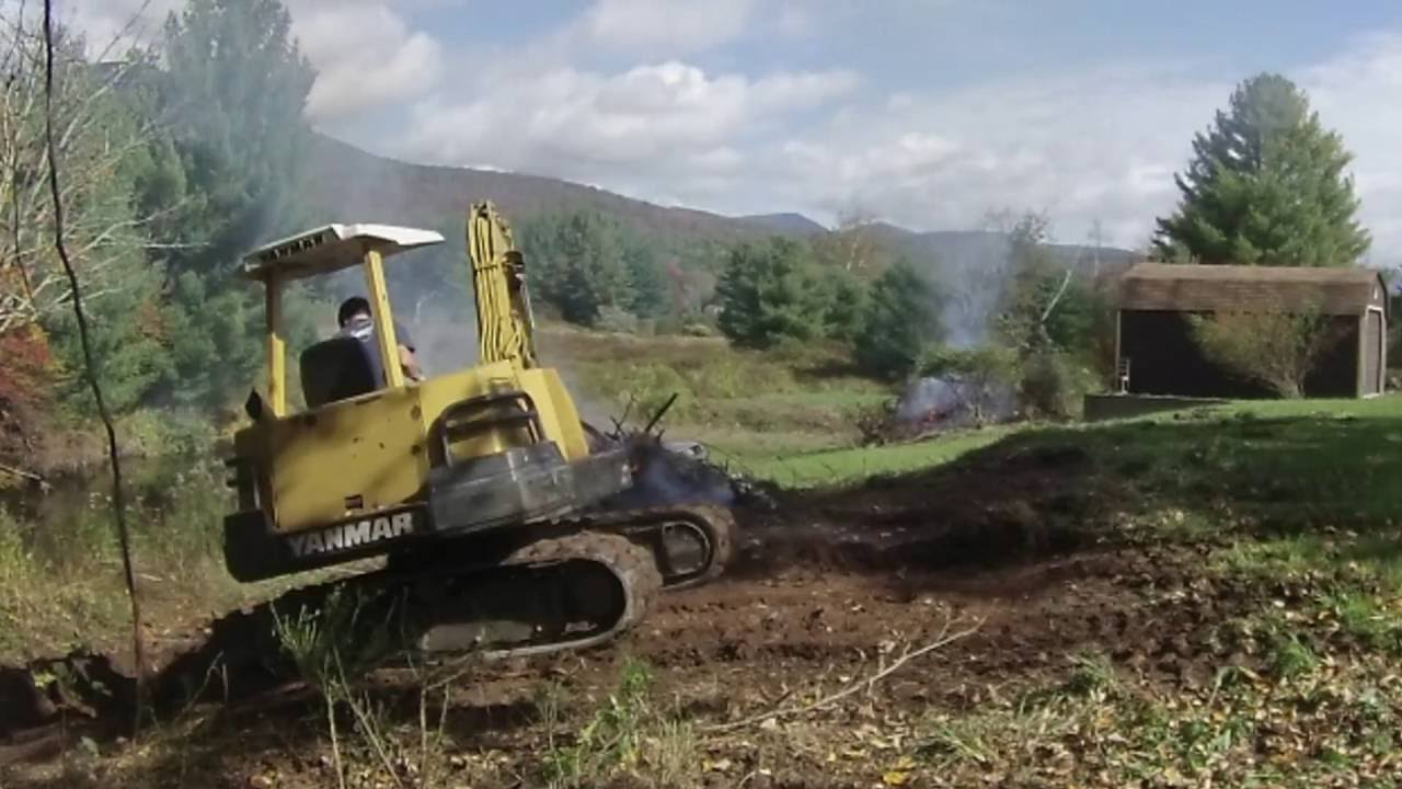 burning brush and grading a hill