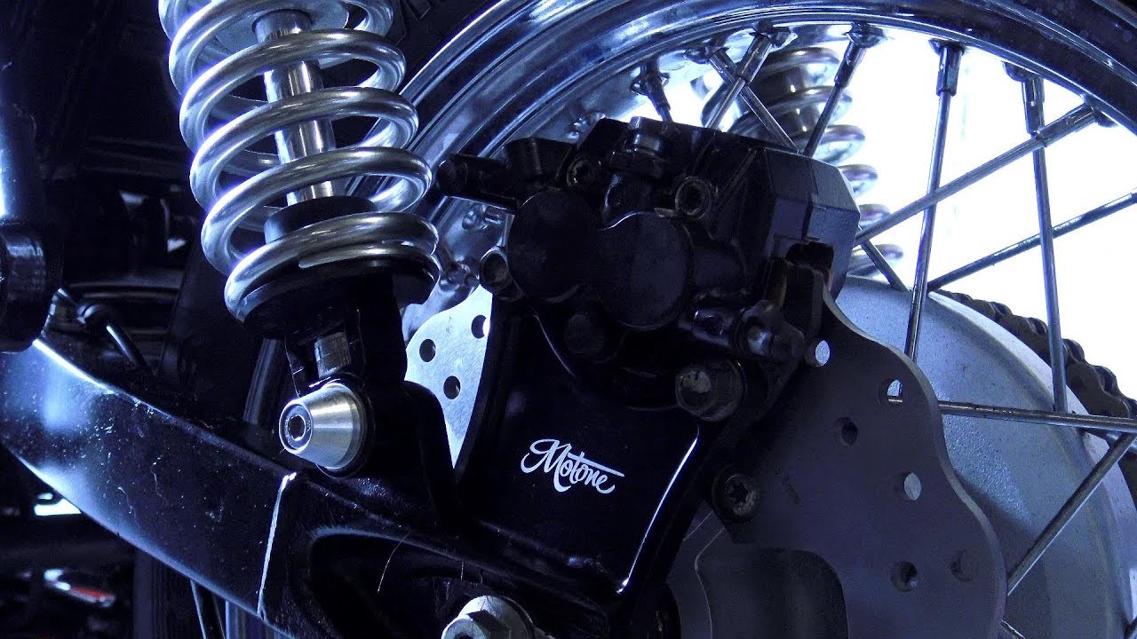 Custom Triumph Bonneville T100, fitting Motone customs brake caliper relocator, disc and pads!