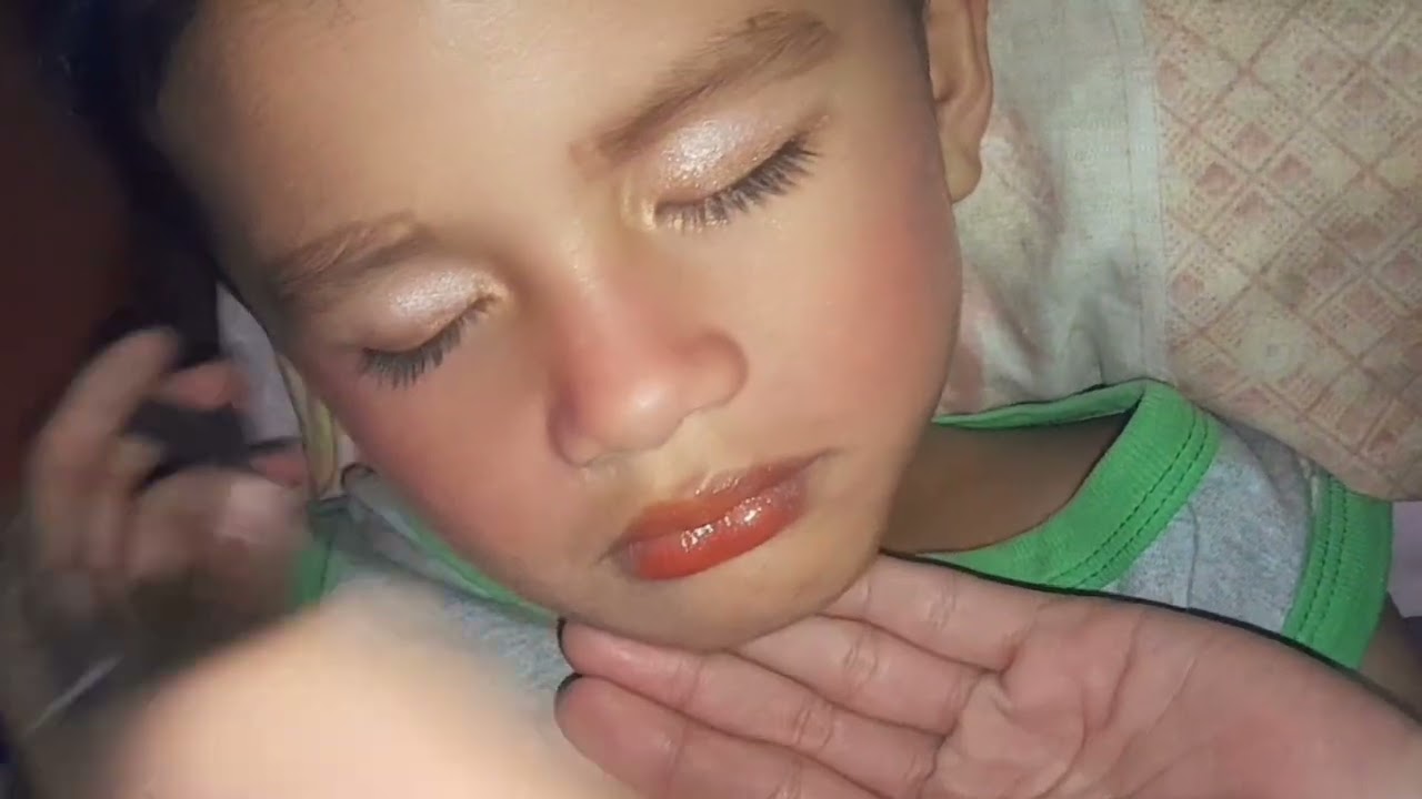 Doing the make up on  our cousin while sleeping