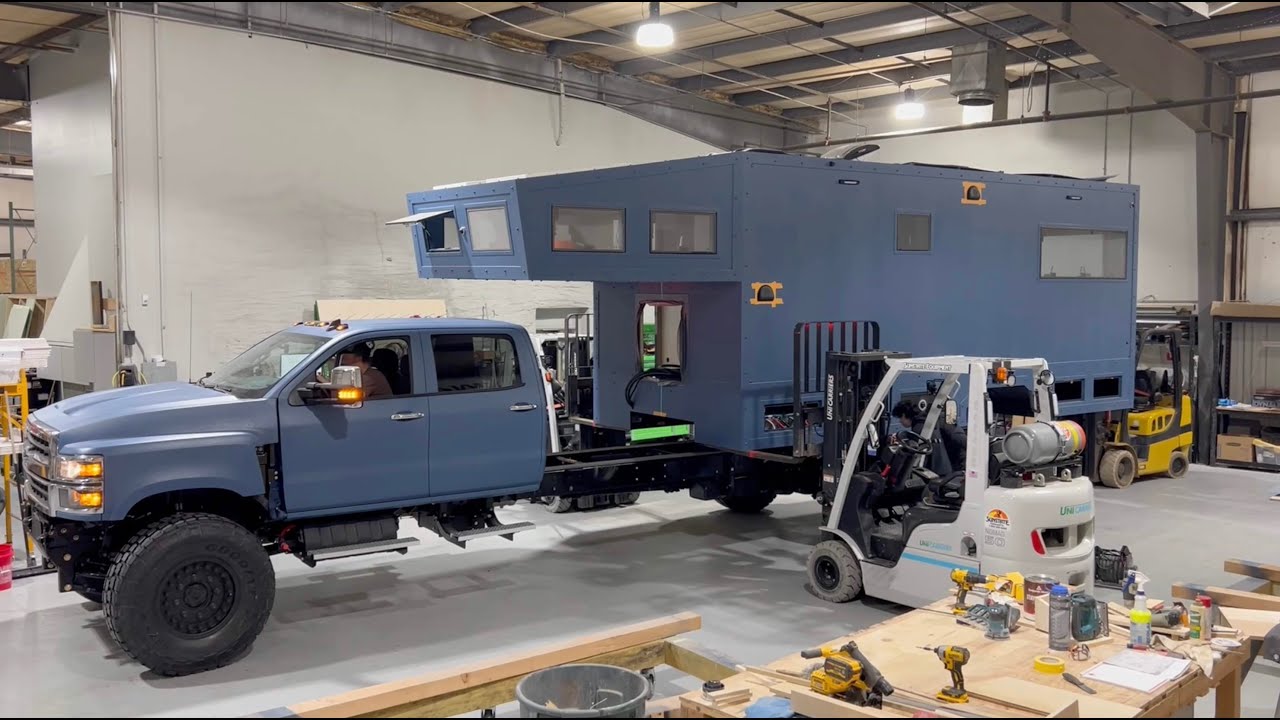 Wanderbox Chevy 35 4x4 camper shell being mounted on truck chassis