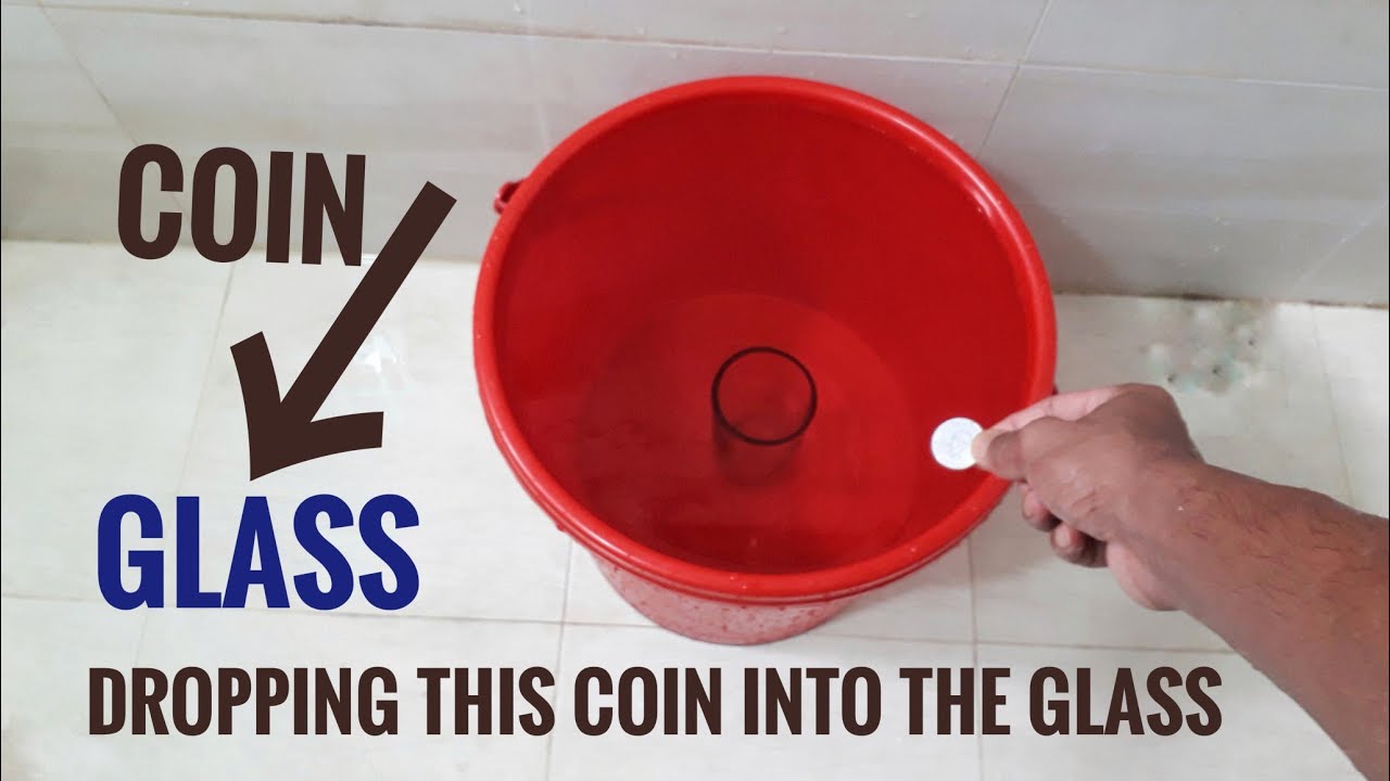 Dropping a coin into a glass which is located within a basket full of water
