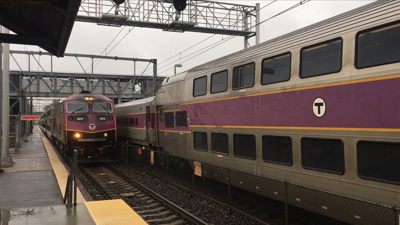 Rainy rush hour trains at Canton Junction MBTA and Amtrak