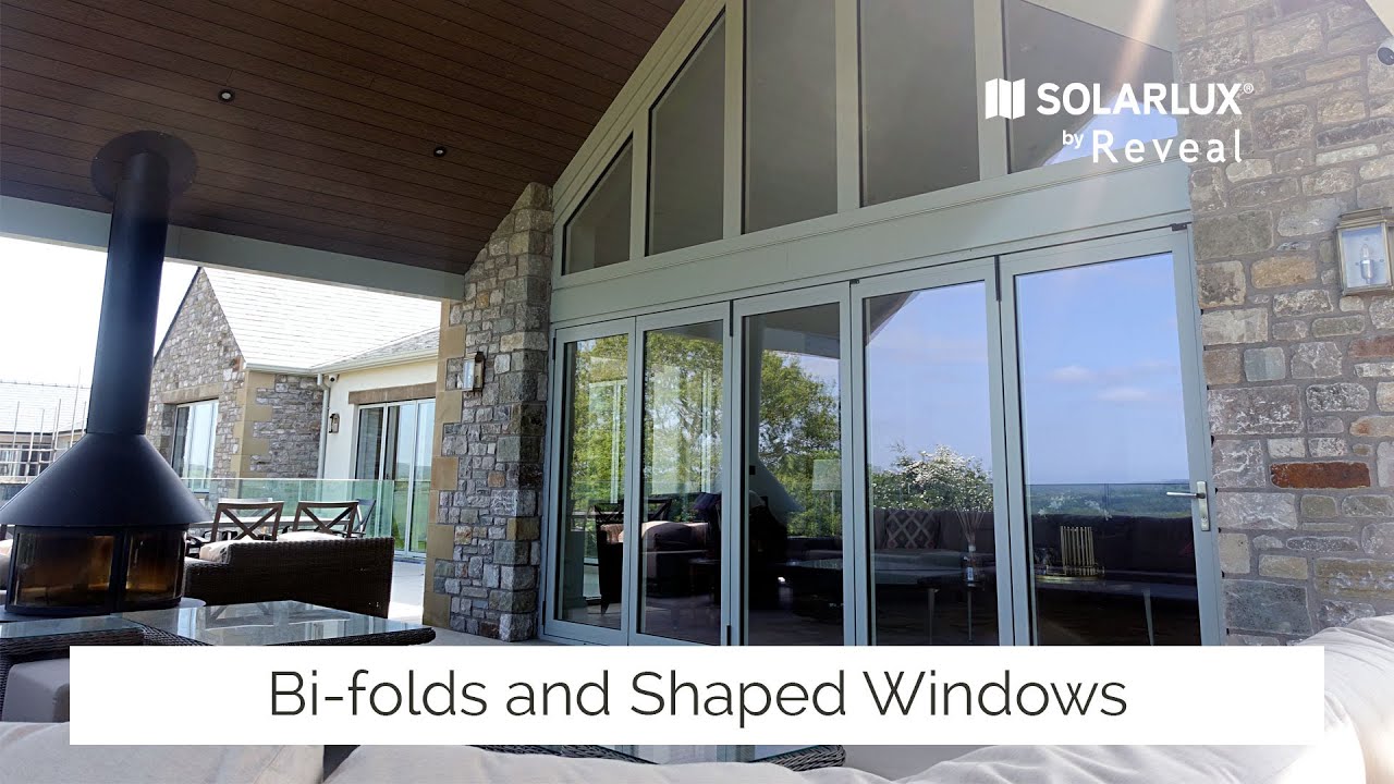 Alu-clad bi-folding doors and shaped windows for new build home