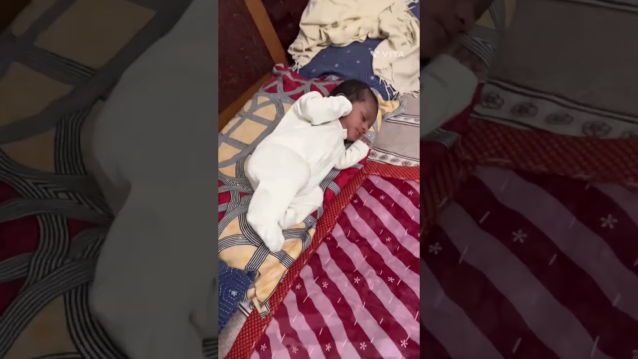 #Small baby falling down from pillow on bed#