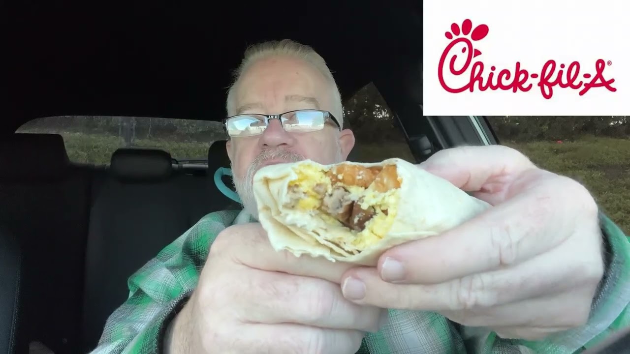Trying Chick-Fil-A's Sausage Hash Brown Scramble Burrito for the first time.