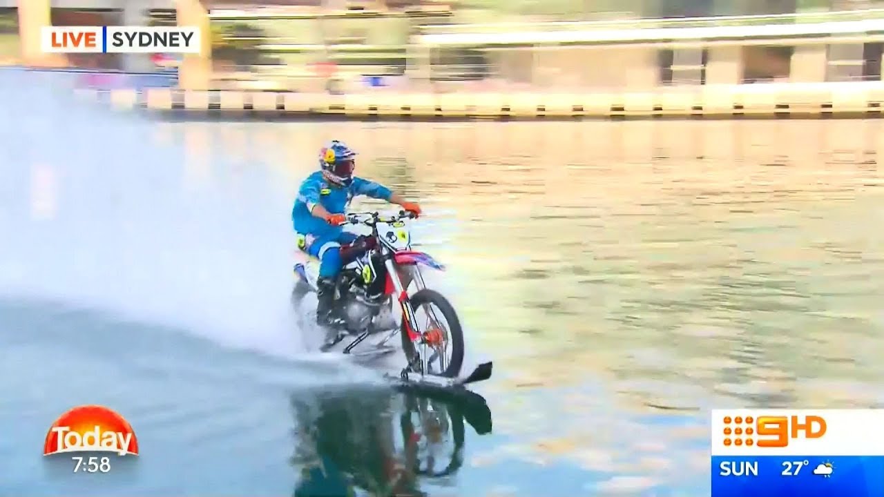 Robbie Maddison rides his Motorbike over waters at Darling Harbour, Sydney
