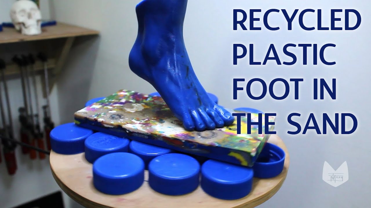Sculpting a Recycled Plastic Foot in the sand