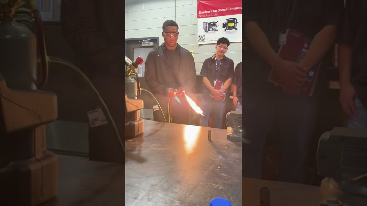 HVAC students learning to light a torch