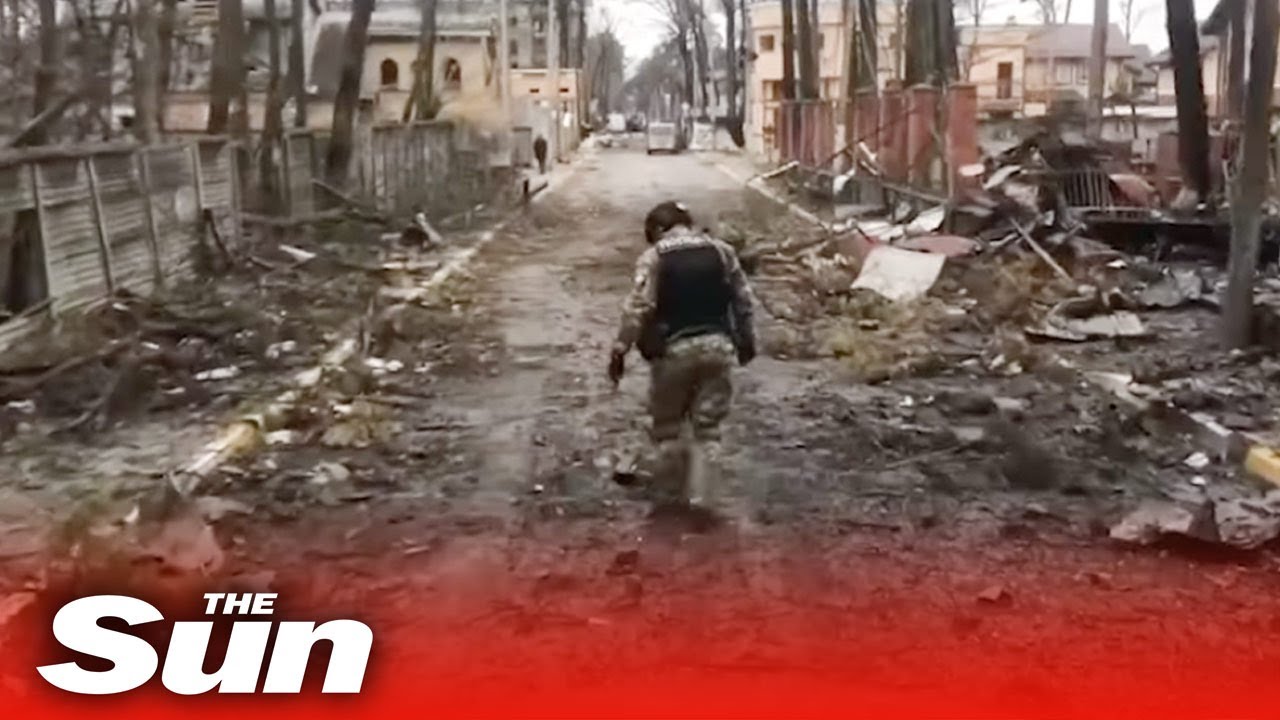 Ukrainian forces survey damage to Irpin littered with Russian 'unexploded ammunition'