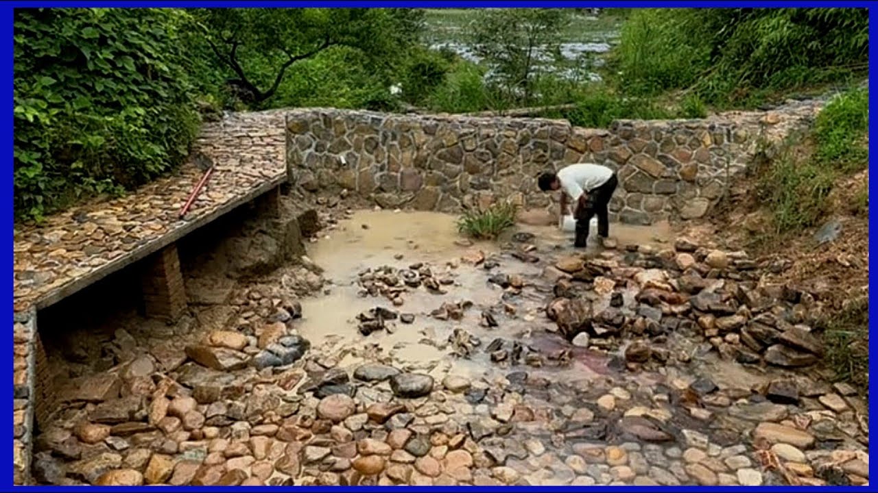 constructing a water storage dam on a small stream