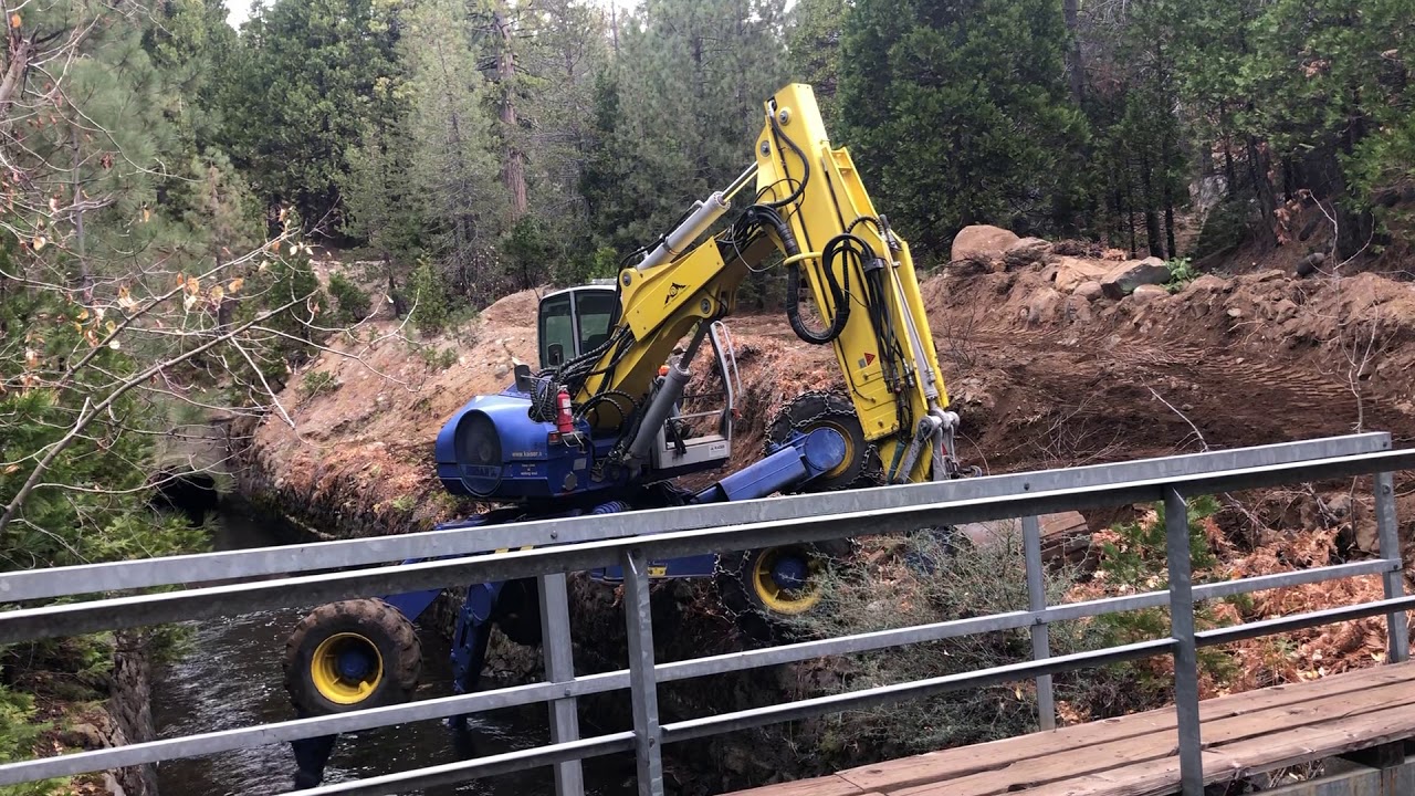 Spider Excavator walks into a canal
