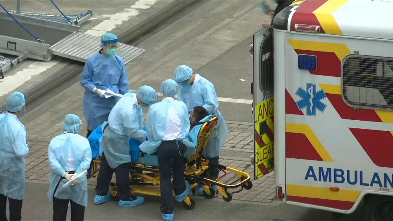 Man taken from HK cruise liner into ambulance after coronavirus check | AFP