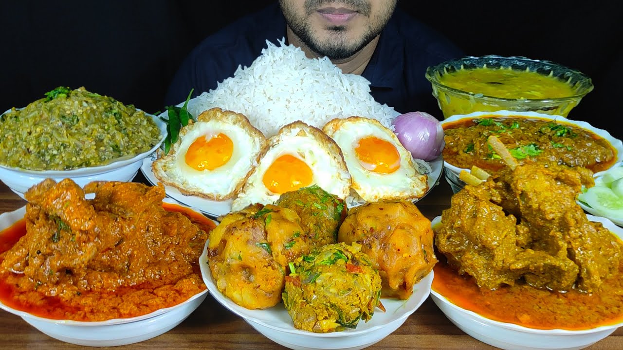 EATING MUTTON CURRY, CHICKEN CURRY, ALU BHORTA, BEGUN BHORTA, FISH BHORTA, DAL, FISH, EGGS WITH RICE