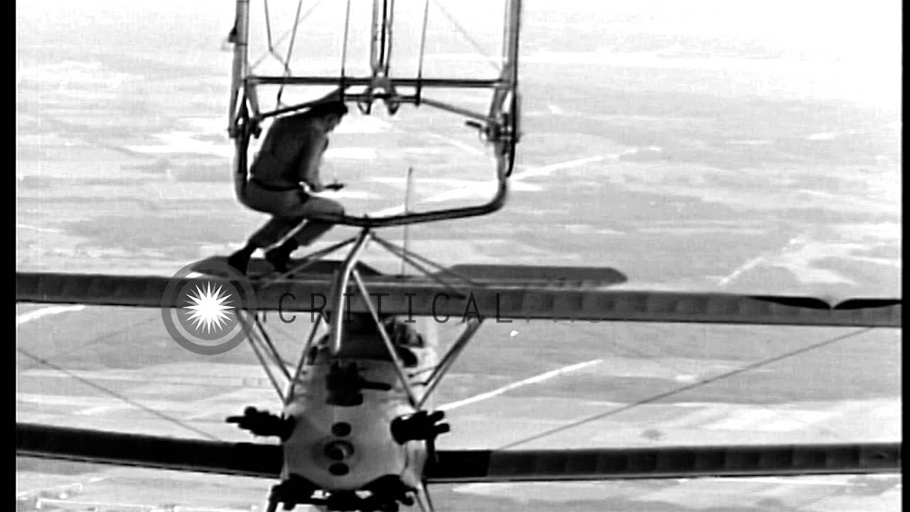 Lieutenant Wayer descends from USS Akron (ZRS-4) to a hooked-up N2Y-1 training pl...HD Stock Footage