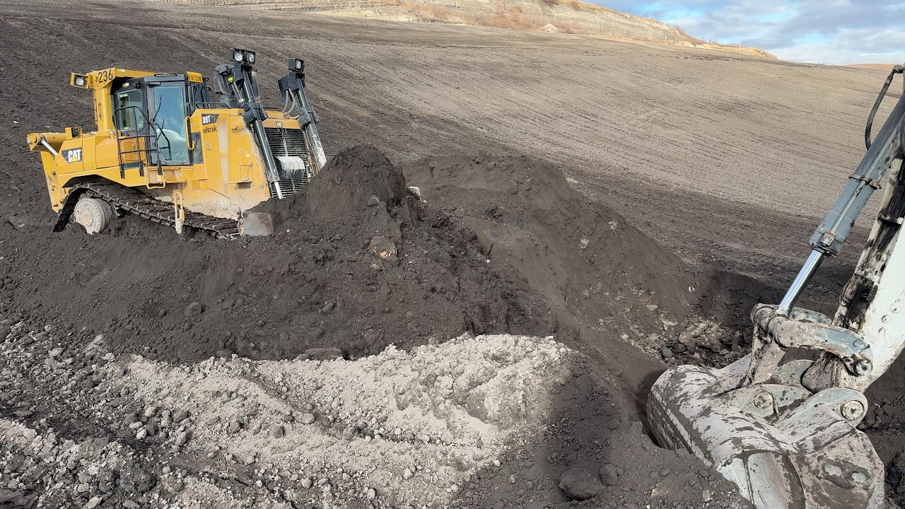 Caterpillar D9T Bulldozer Pushing Overburden On Liebherr 984 Excavator
