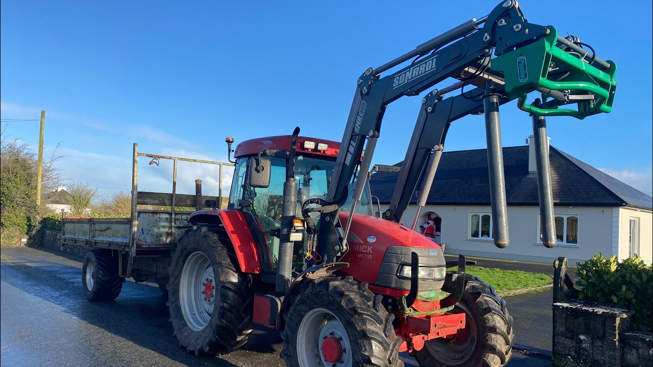 McCormick MC115 loading bales