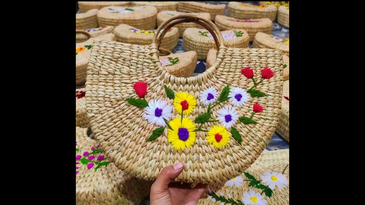 straw bags with hand made embroidery designs on it
