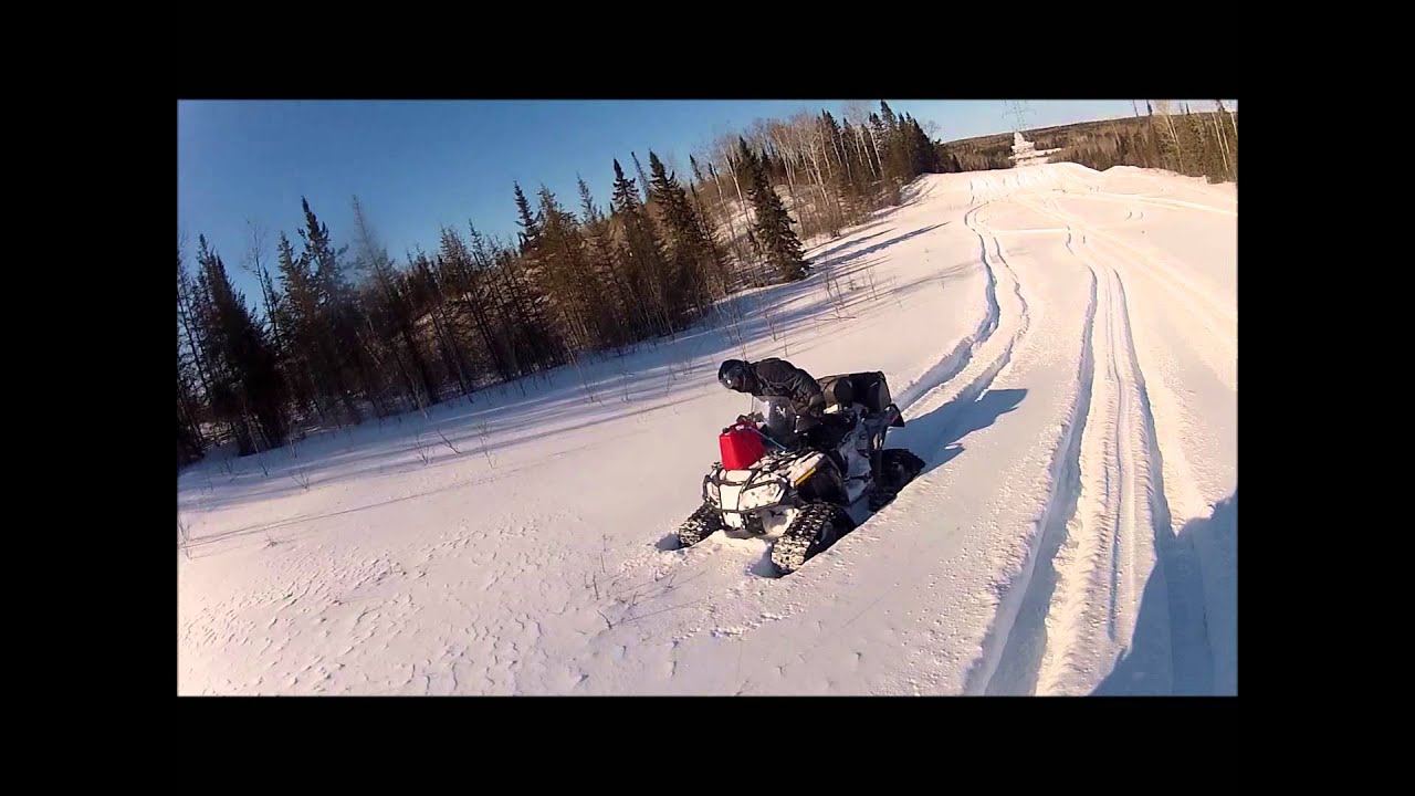 ATV's on tracks riding in deep snow ..