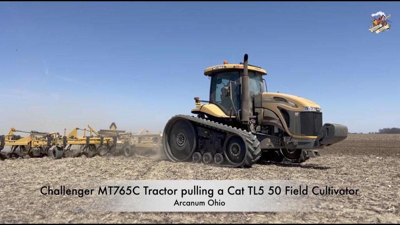 Challenger MT765C Tractor pulling a  Cat TL5 50 Field Cultivator