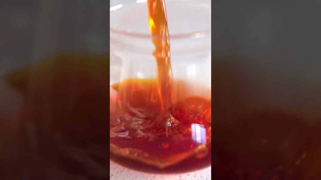 a dramatic slow coffee pour into a sense orea cup