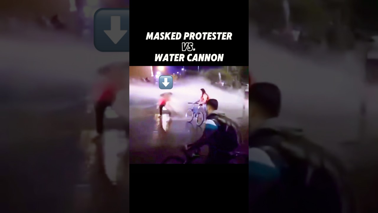 Masked Protester vs. Police Water Cannon