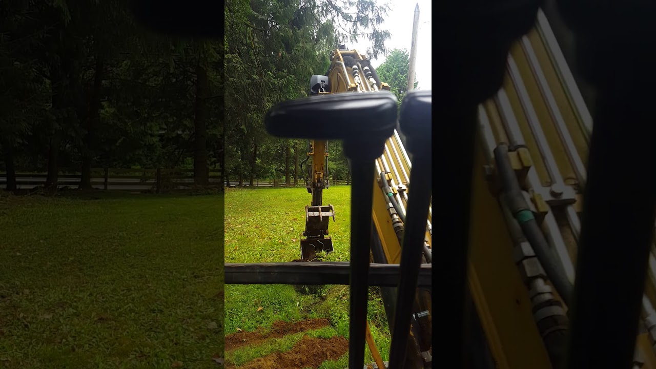 Cat 303.5 digging a stump